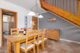 Ferienhaus Paula - Wohnzimmer mit Essbereich und Zugang zur Terrasse