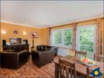 Ferienwohnung am Krebssee Whg. Otter - Wohnbereich mit Couch und TV