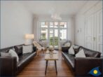 Appartement Agata - Wohnbereich mit Couch, TV und Blick zum Balkon