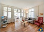 Ostseevilla Whg. 04 - Wohnzimmer mit offener Küche und Zugang zum Balkon
