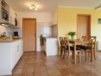 Ferienwohnung Bergstraße 01 - strandnah & entspannen - Wohnbereich mit offener Küche und Zugang zur Sonnenterrasse