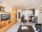 Villa Strandperle, Whg. 04 - Wohnzimmer mit Essplatz, offener Küche und Zugang zur Terrasse