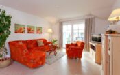 Residenz Sonnenhof Whg. 31 - Sonnenbalkon trifft Ostseeluft - Wohnbereich mit offener Küche und Zugang zum Balkon