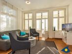 Ostseevilla Whg. 03 - Wohnzimmer mit Couch und TV und Zugang zur Loggia