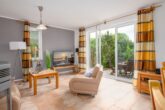 Ferienhaus Paul - Wohnzimmer mit Essbereich und Zugang zur Terrasse