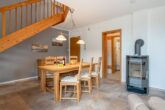 Ferienhaus Paul - Wohnzimmer mit Essbereich und Zugang zur Terrasse